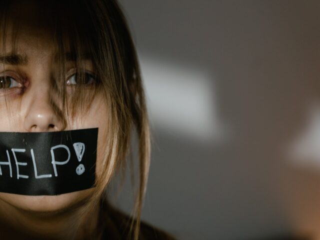 a woman with tape on her mouth